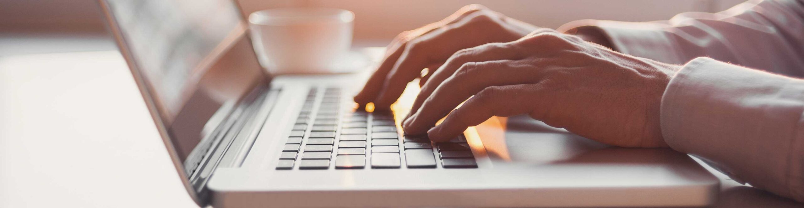 resource-center-slider-image Man typing at a computer - Resource center